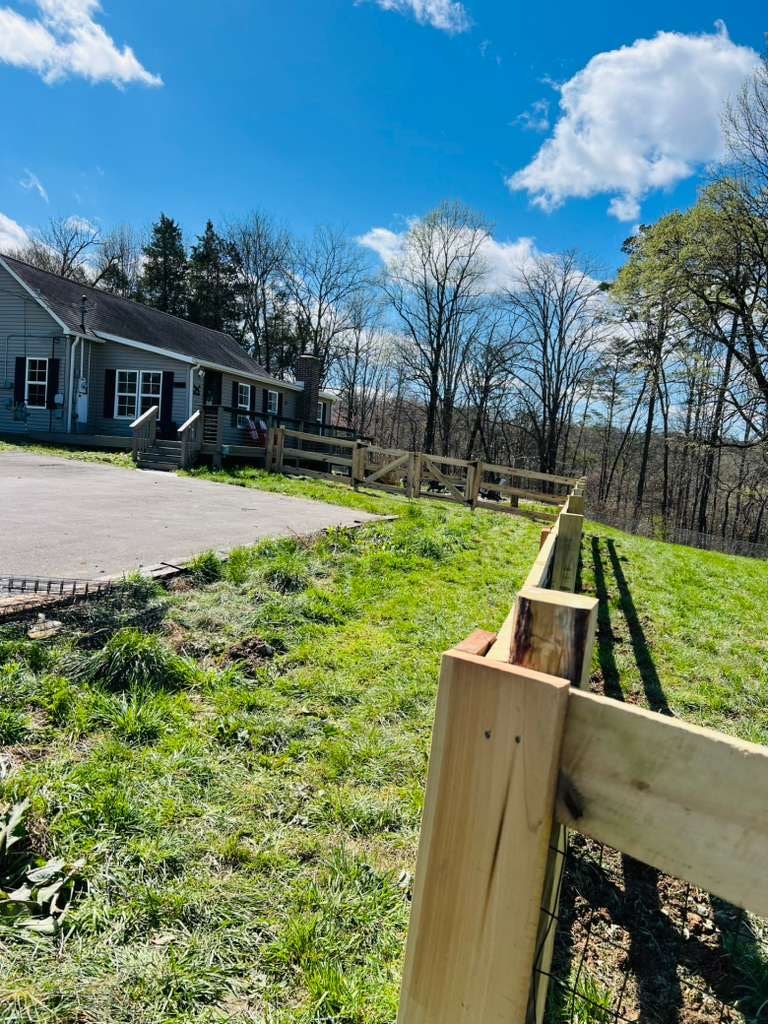 3 rail Kentucky board fence at residential property with house — East Tennessee