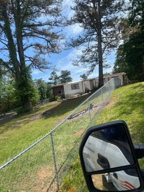 Chain link fence on hillside residential property — East Tennessee