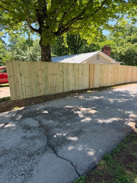 6 foot wood privacy fence with gate beside driveway — East Tennessee