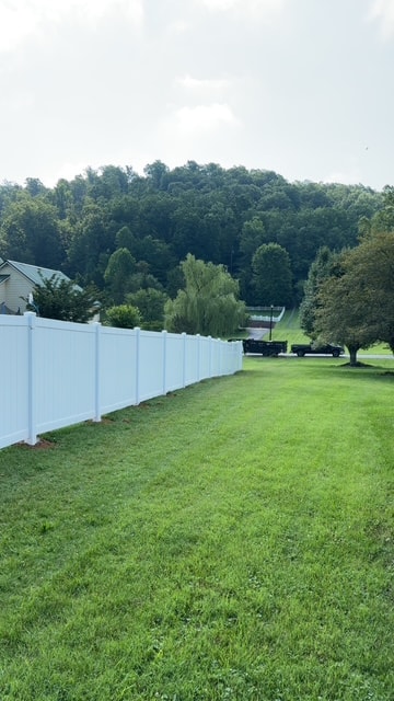 6 foot white vinyl fence long run with tree line — East Tennessee