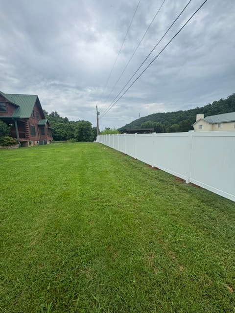6 foot white vinyl fence beside log cabin — East Tennessee