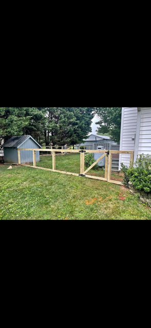 Wood frame and hog wire chicken coop enclosure with gate — residential East Tennessee