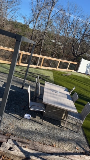 Completed hog wire and wood frame fence surrounding backyard patio — Maryville, TN